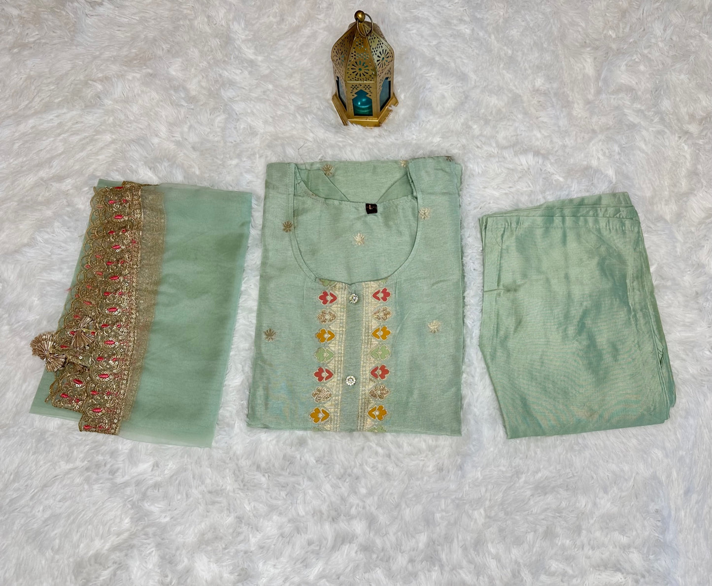 Pastel green suit with bottom and lace work dupatta.