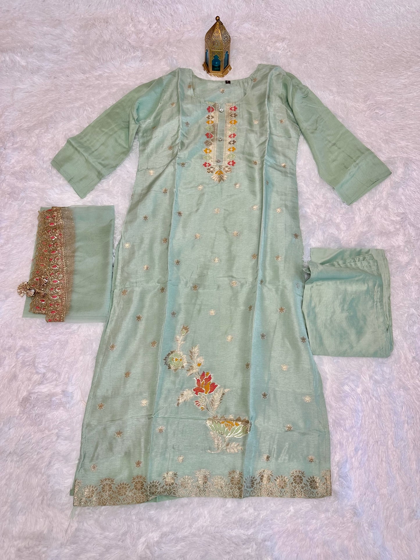 Pastel green suit with bottom and lace work dupatta.