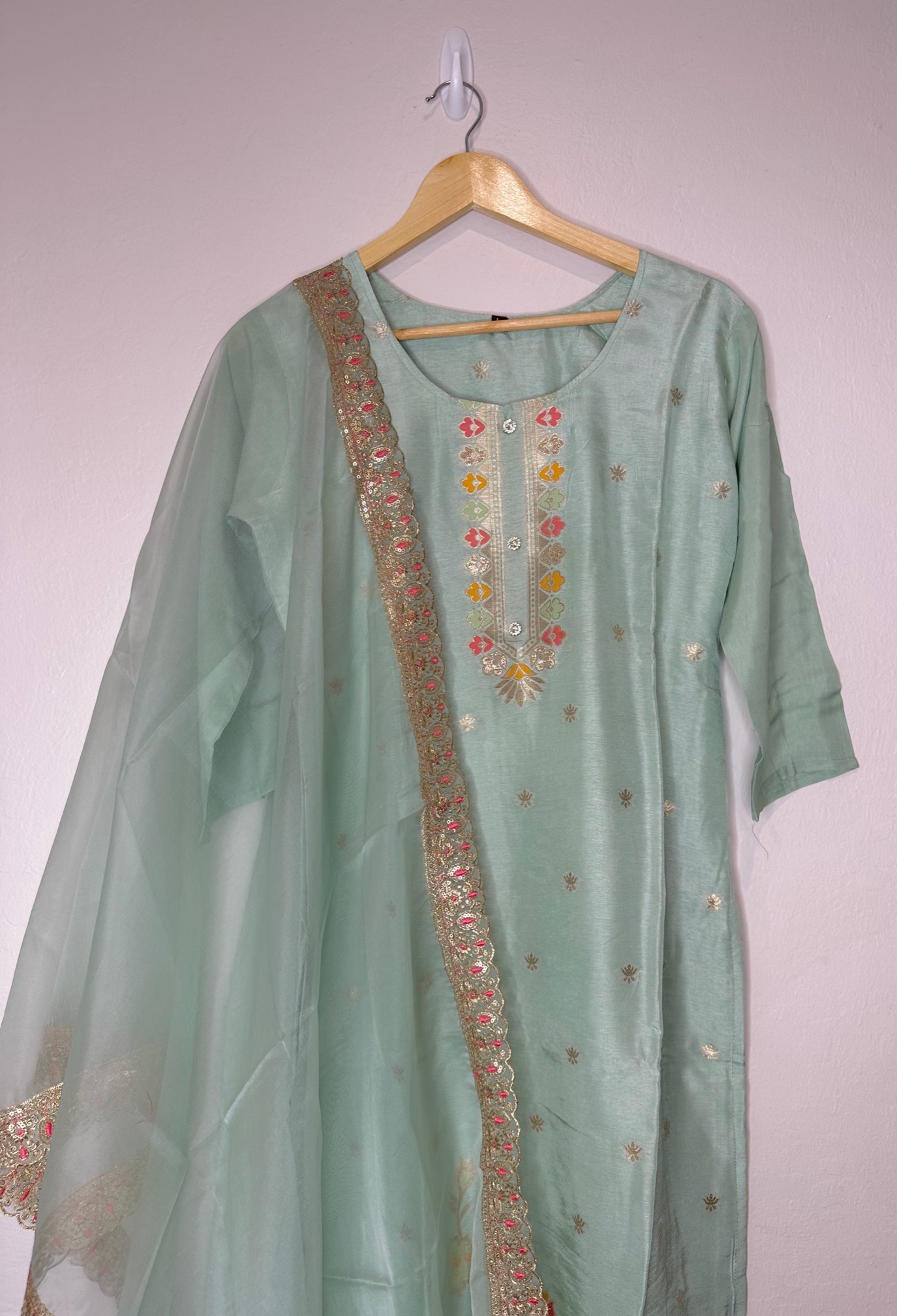 Pastel green suit with bottom and lace work dupatta.