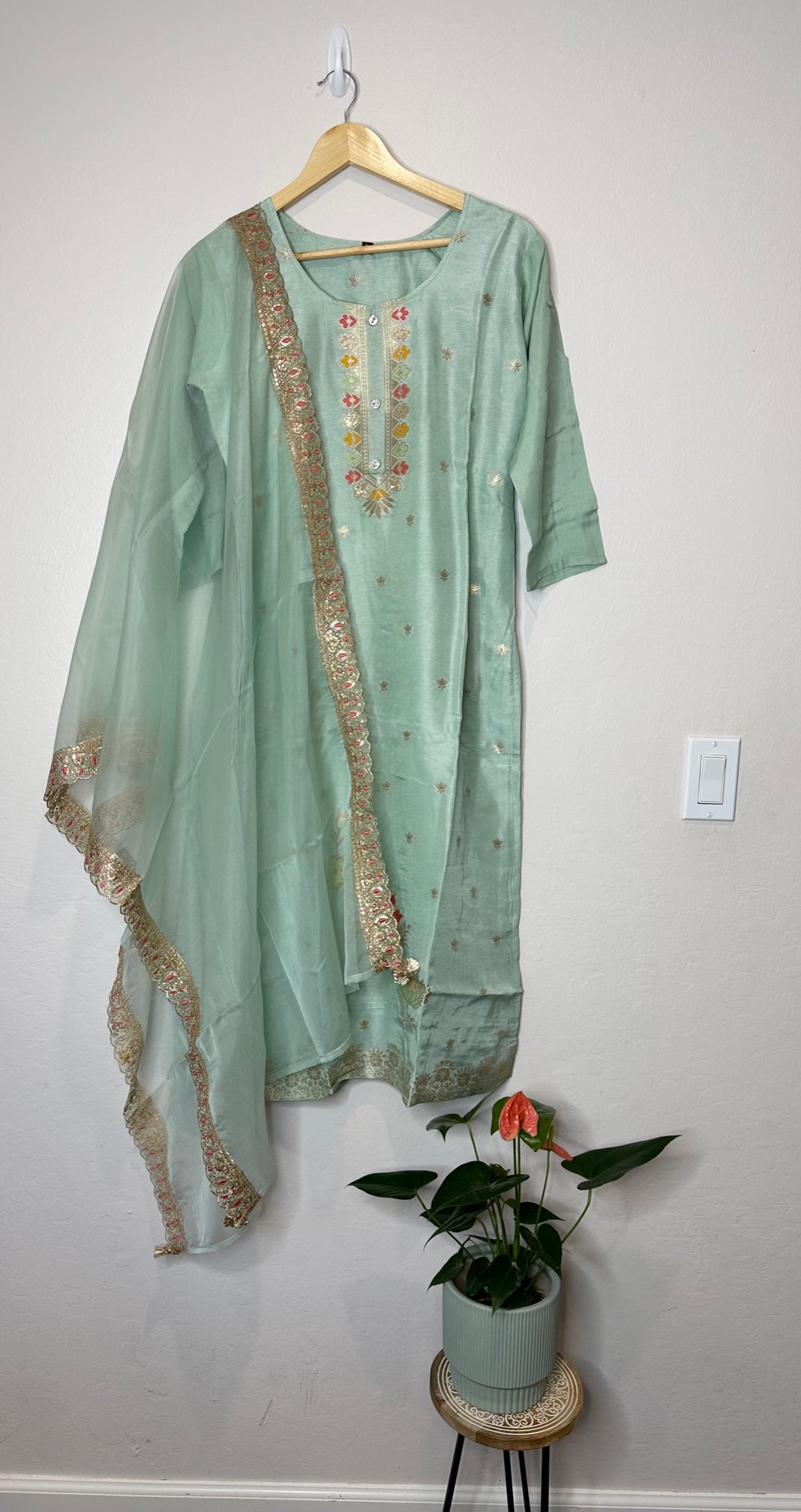 Pastel green suit with bottom and lace work dupatta.